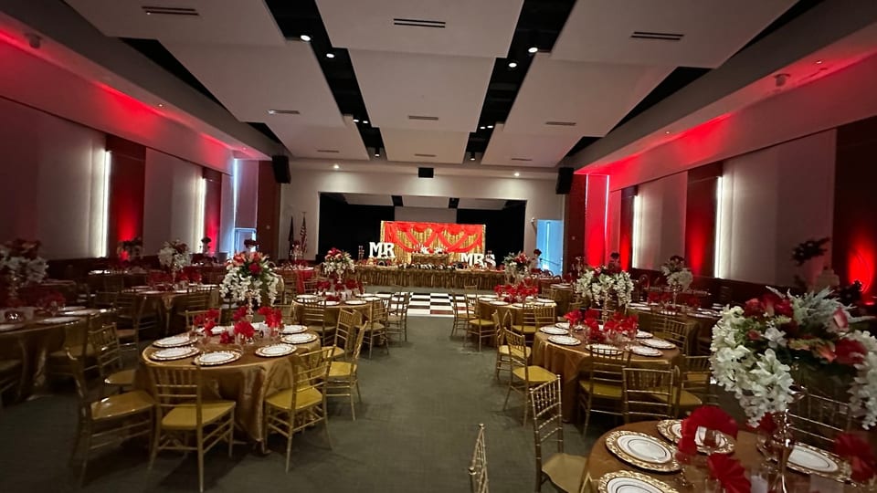 Red uplighting transforming a decorated wedding reception venue